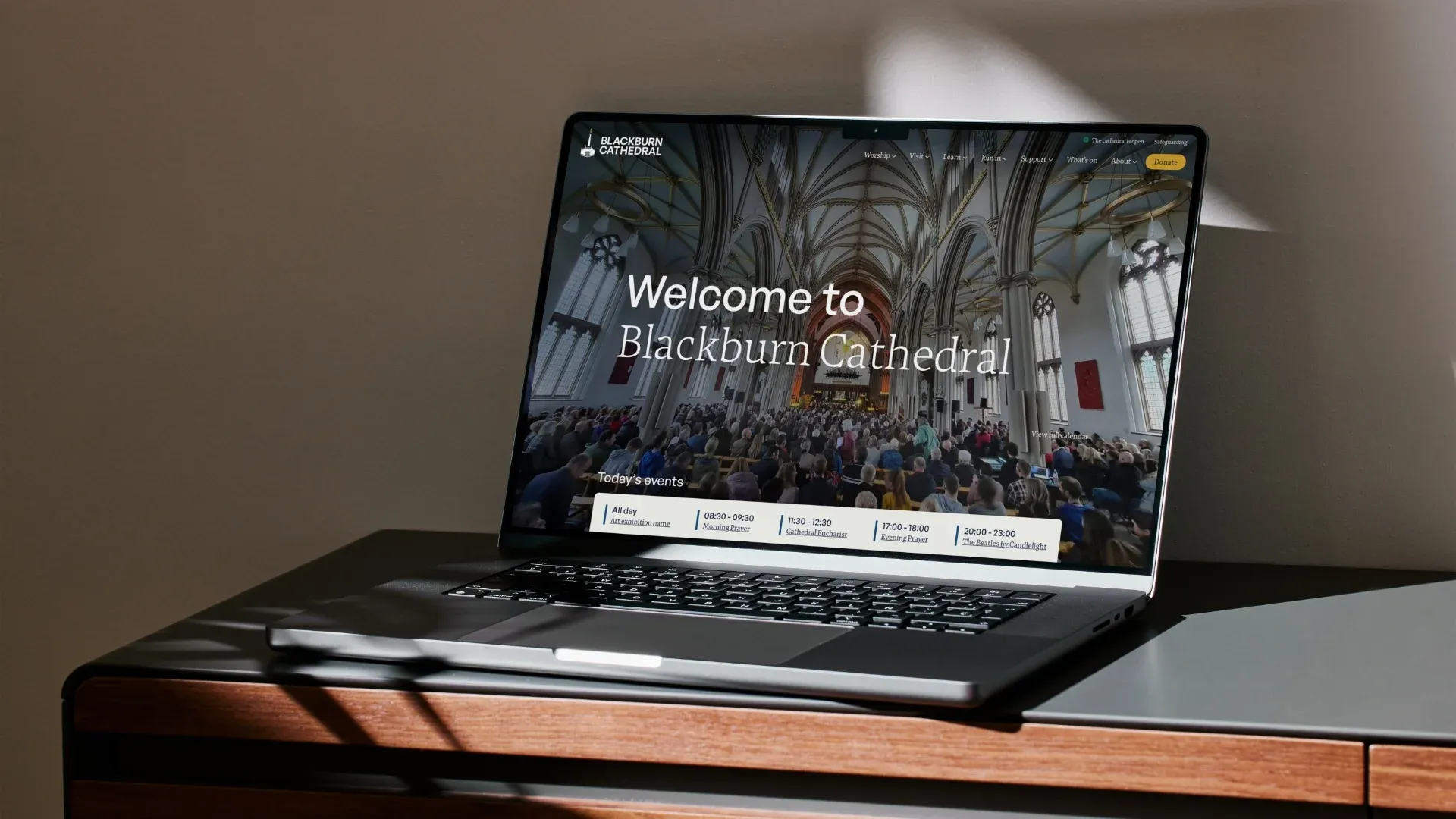 The new blackburn cathedral homepage on a laptop