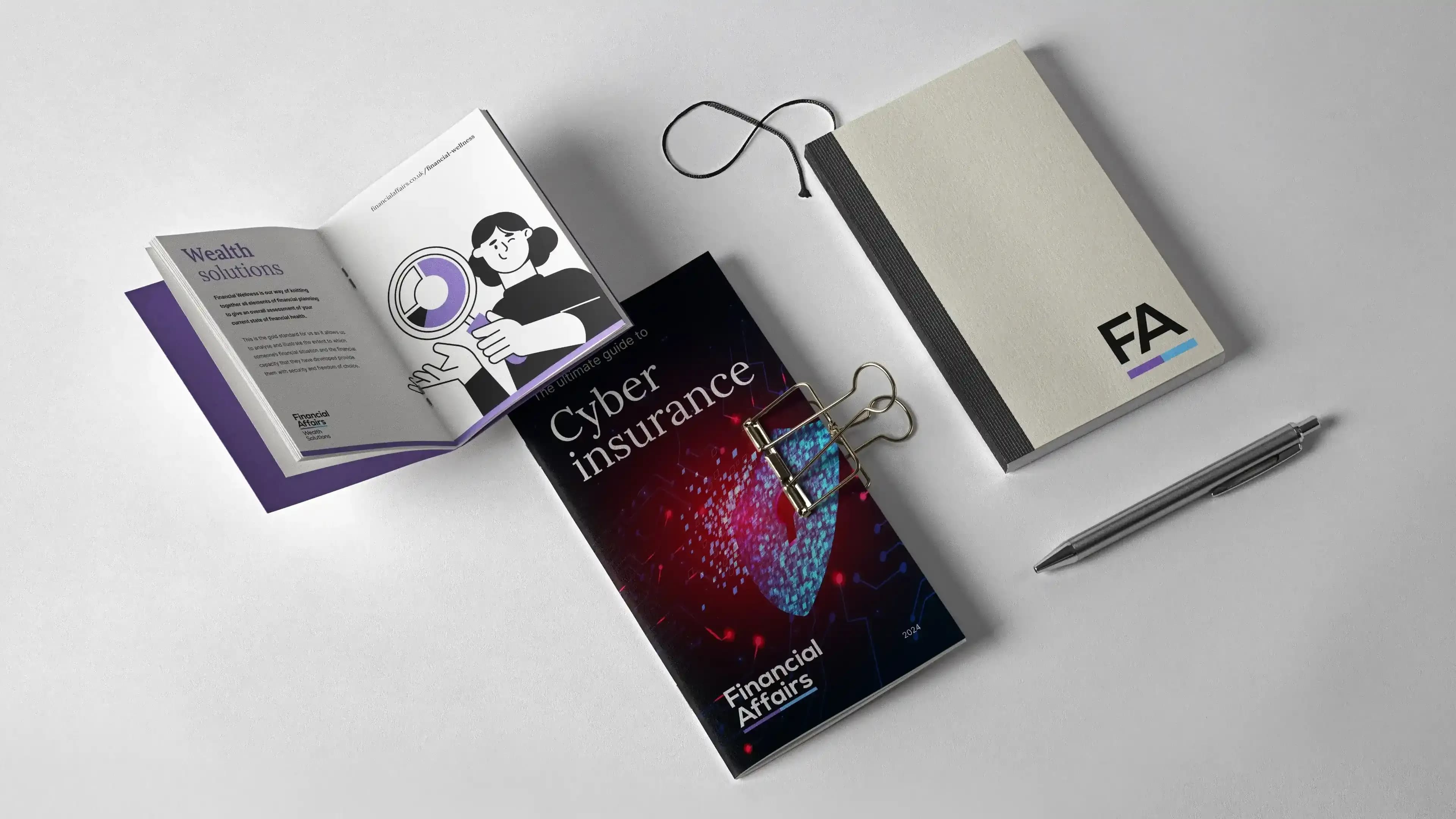 The cyber insurance guide alongside a branded notepad
