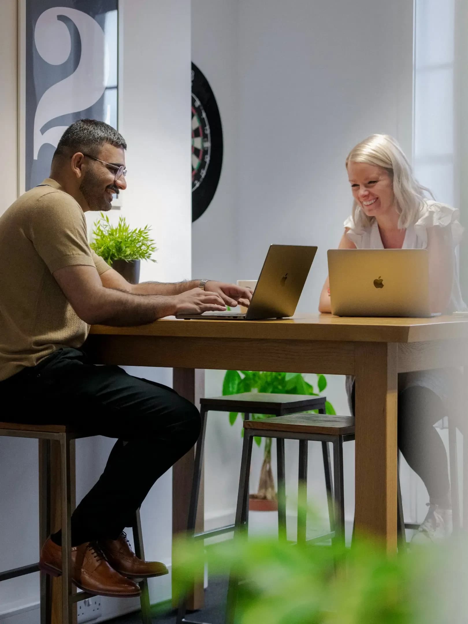 Z and Lindsay chatting at a desk