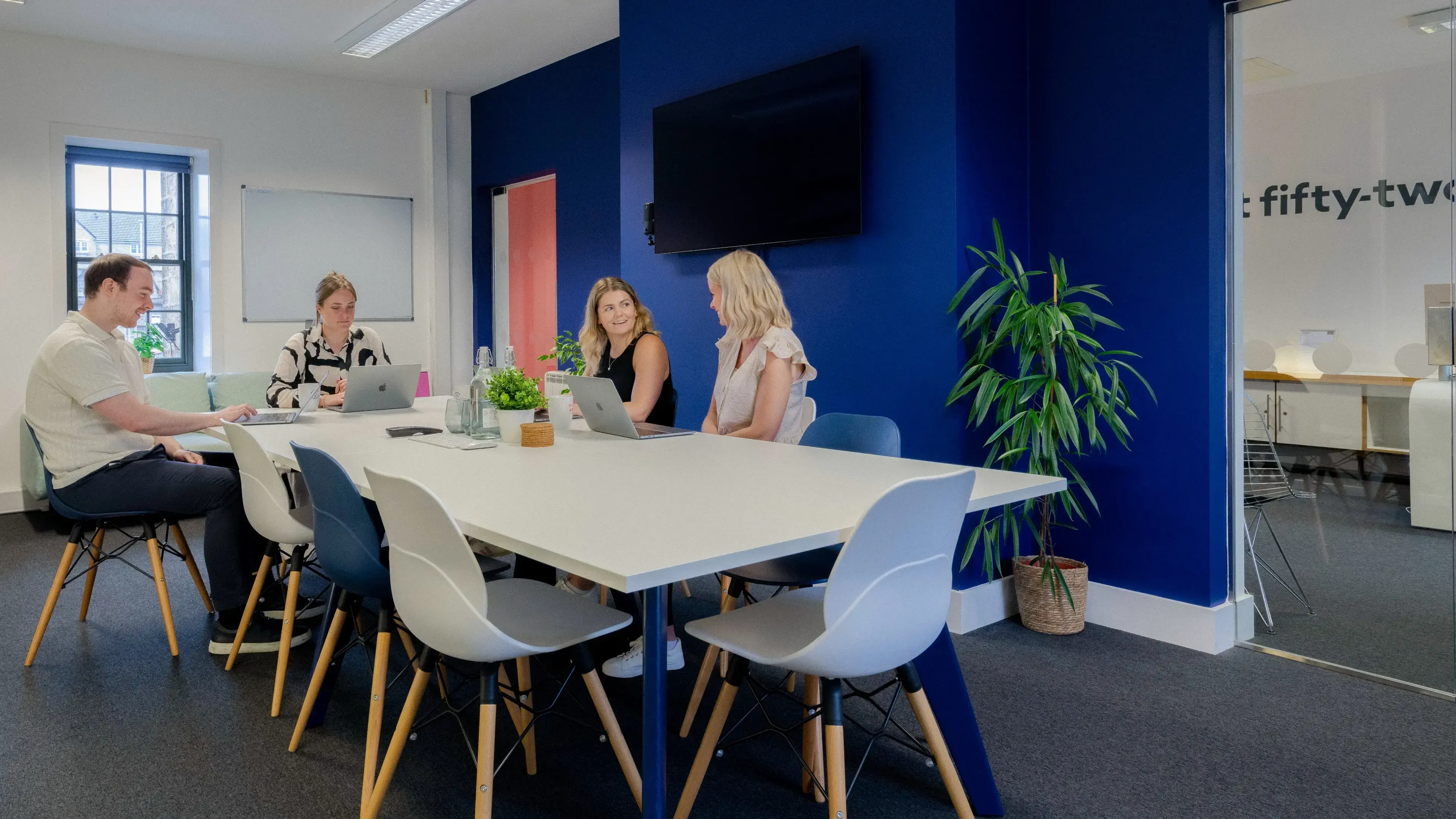 The team discussing a website around a table